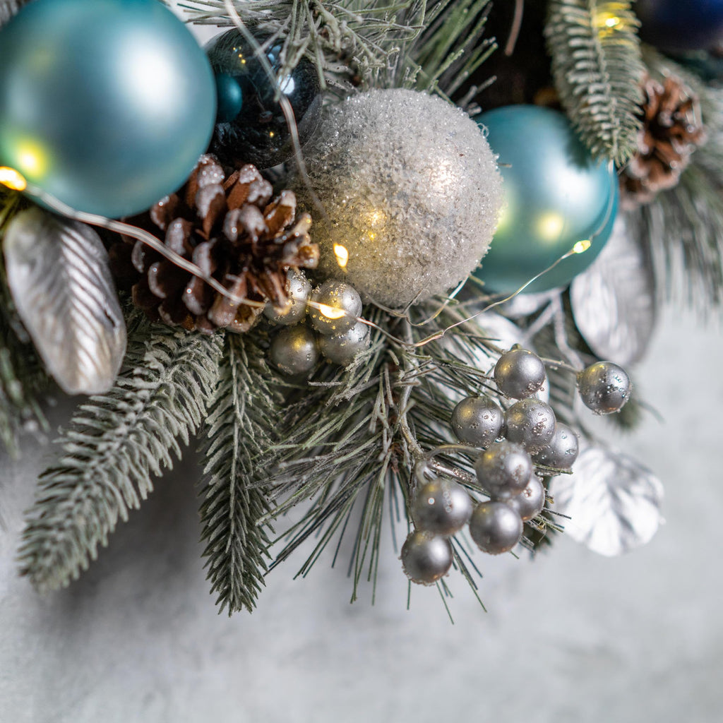 YULETIME 20-inch Christmas Wreath, Battery Operated Holiday Wreath with 20 Fairy Lights, Blue Baubles, Silvery Berries, Pine Cones, Silvery Leaves, Frosted Spruce Branches and Pine Needles (Blue)