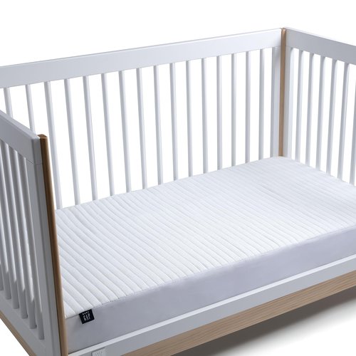 Crib Mattress Protector for Infants and Toddlers - Waterproof, Cooling, Soft Quilted, Elastic, and Washable Baby Mattress Protector in White, Quiet Comfort by babyGap